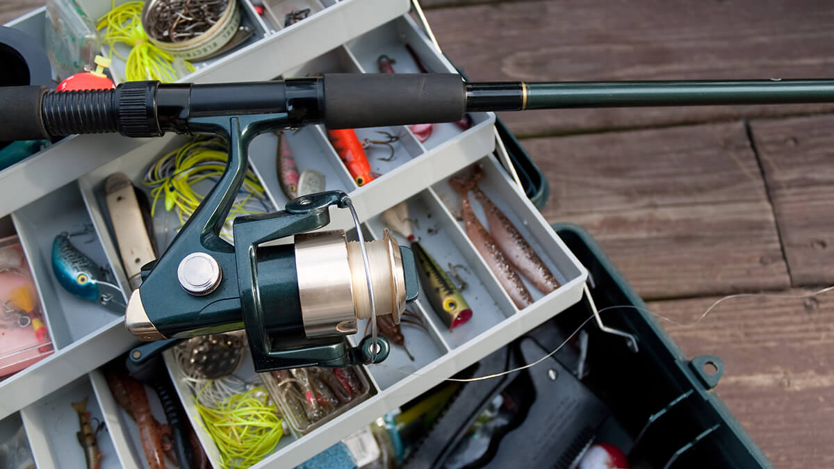 A man fishing from canoe on lake