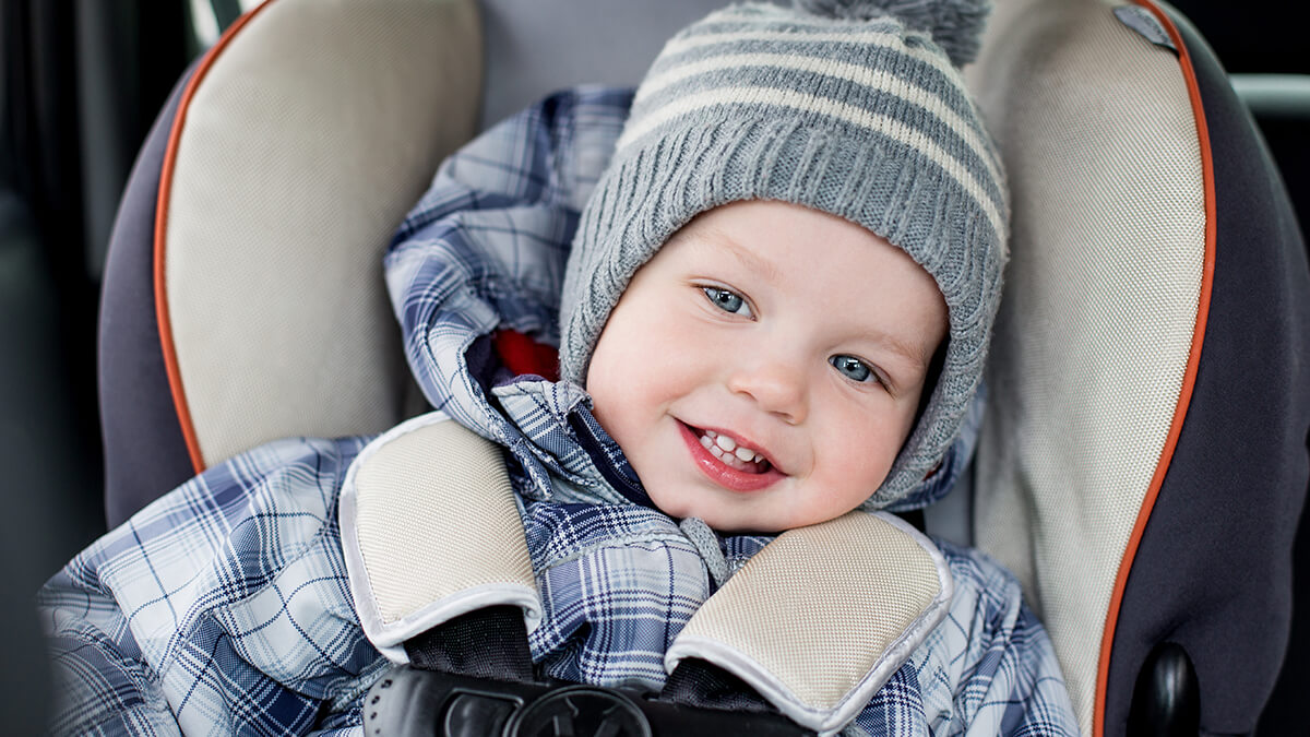 A car driving through a half-plowed snow covered road