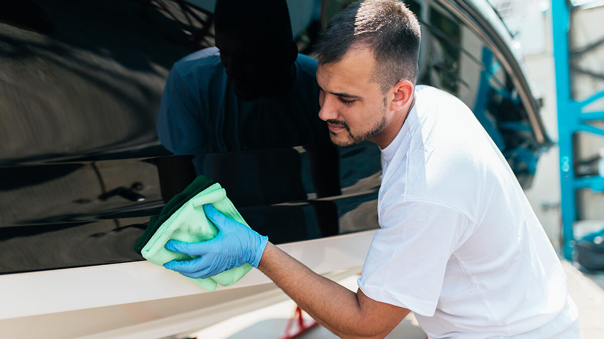A close-up of hands adjusting something on a boat engine