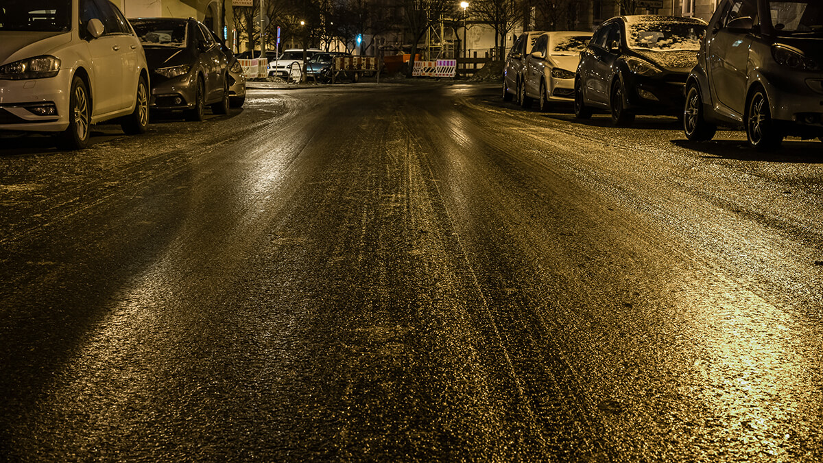 Colored lights reflecting off a slick icy road