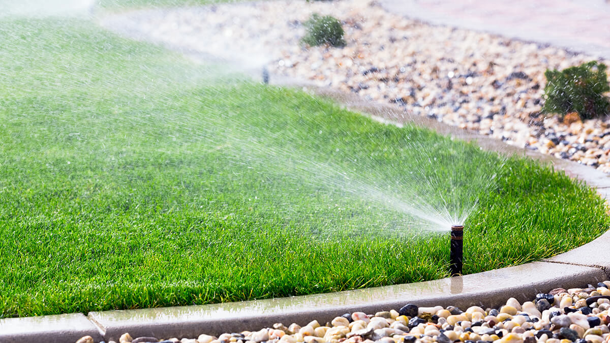 A homeowner power washing his deck