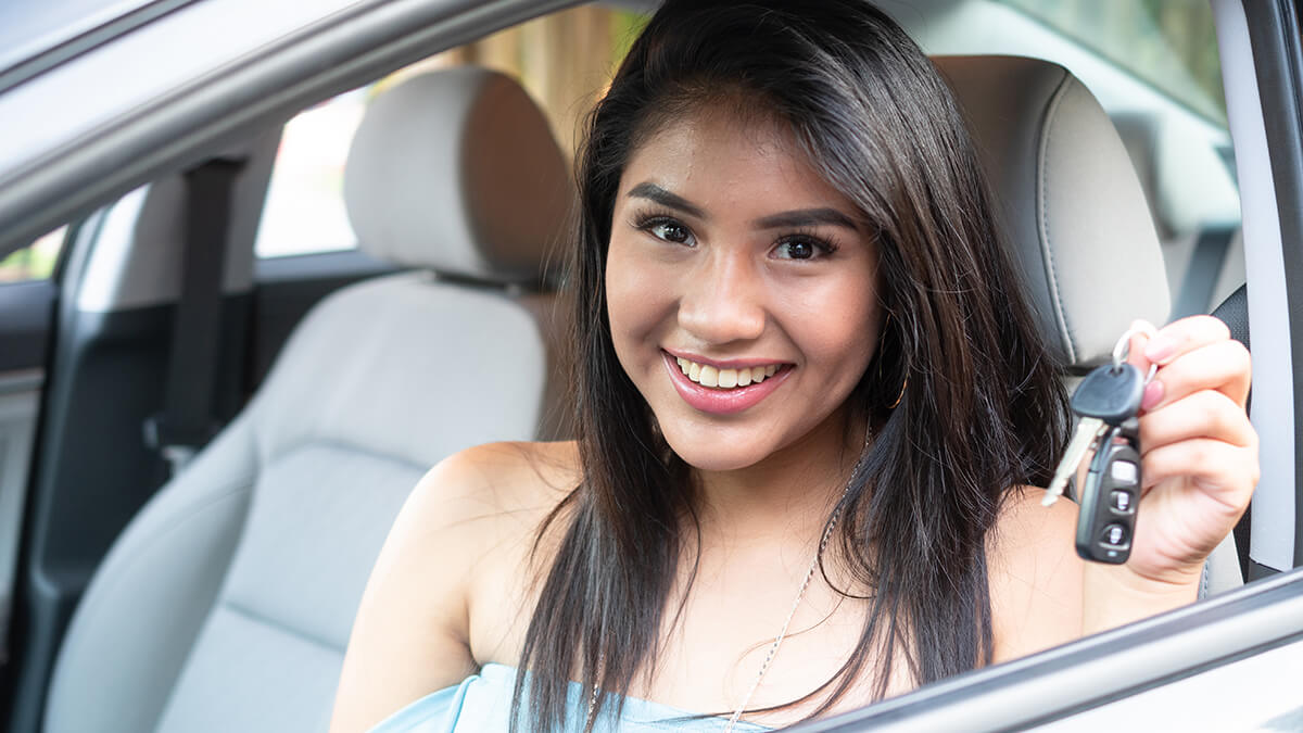 Mother and daughter driving with daughter at wheel