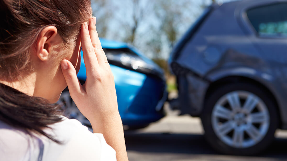 A snowmobiler following a well traveled path through hills