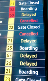 Staying sane when stuck at the airport Multi-colored Airport Flight Board Showing Delays and Cancellations