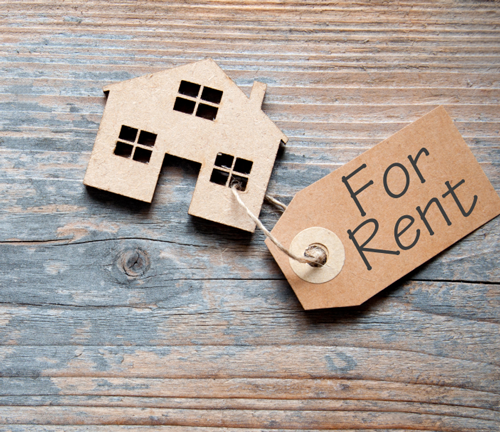 House cut out with a for rent sign