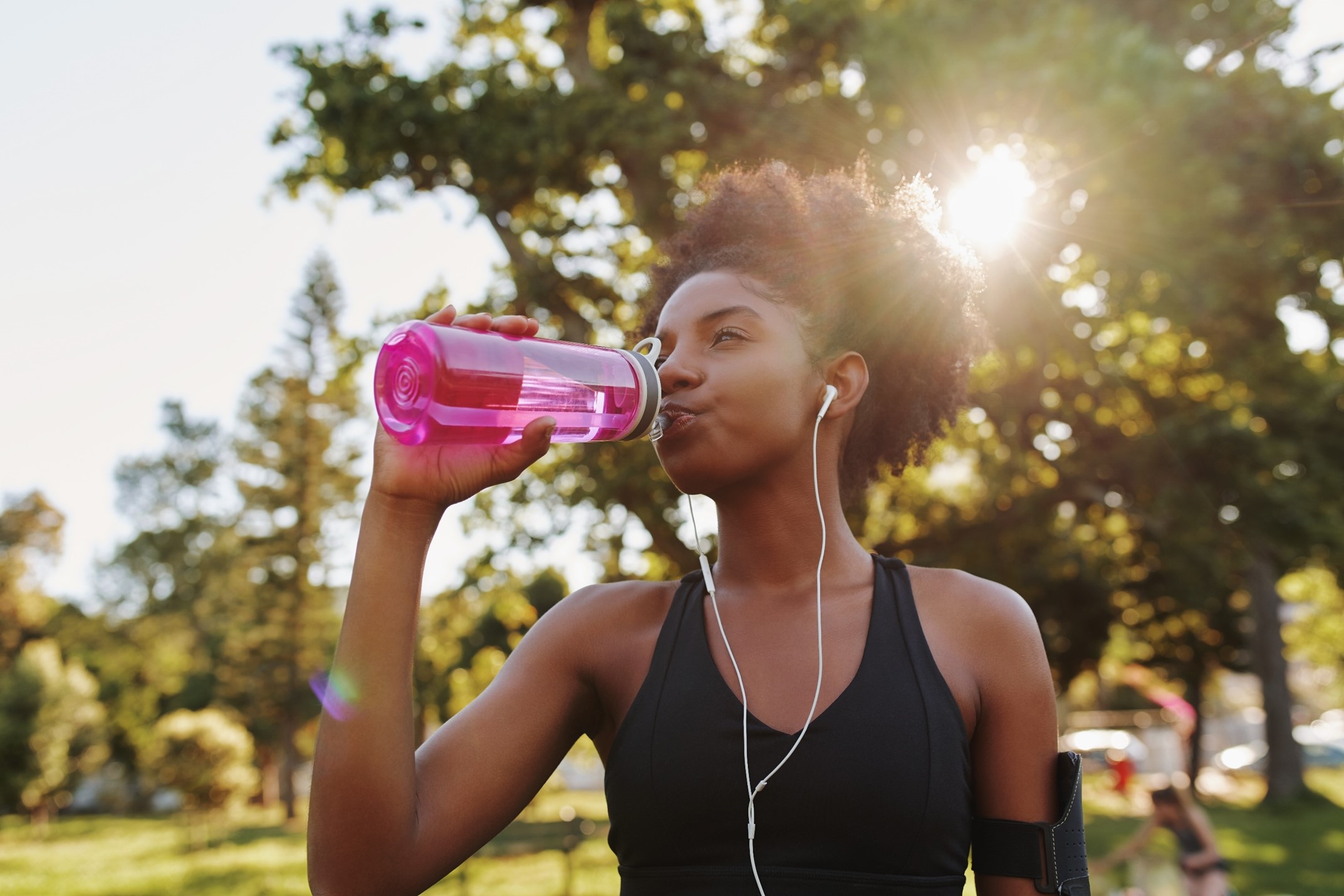 Woman out walking drink from a water bottle