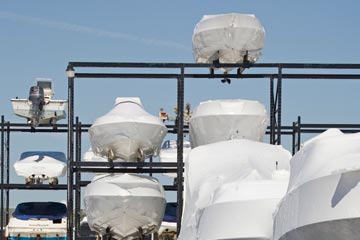 A group of boats off the ground and covered
